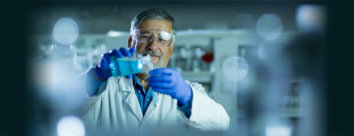 Senior male researcher carrying out scientific research in a lab shallow DOF;