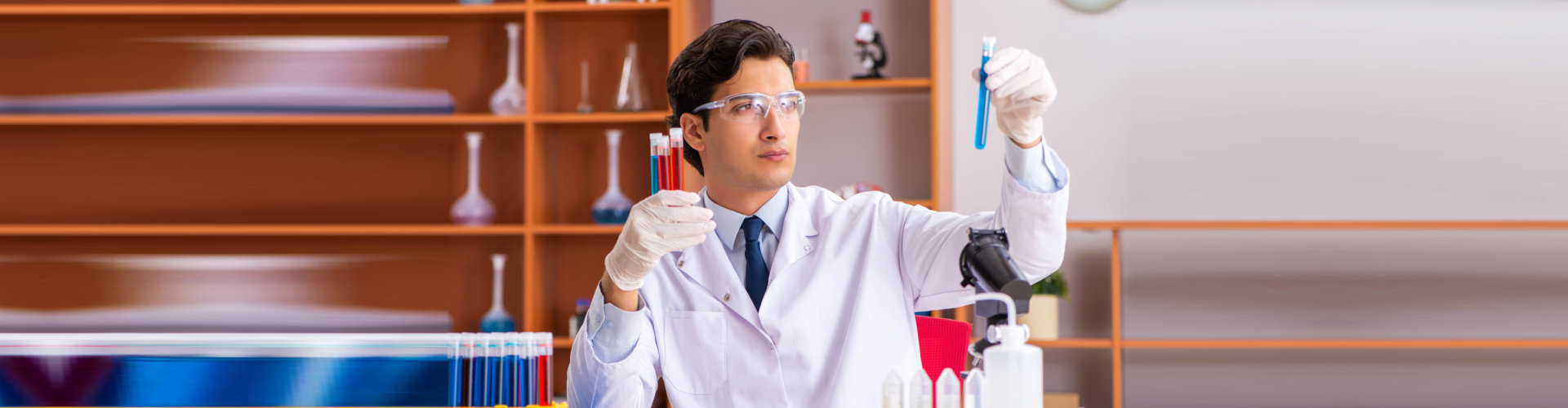 chemist holding test tubes with chemicals